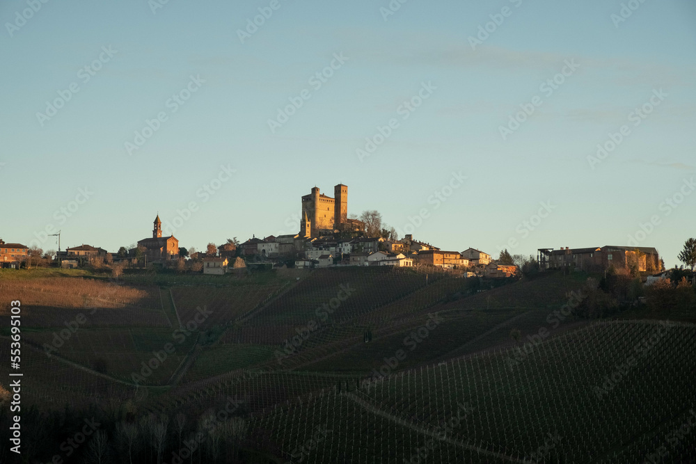 the castle of serralunga d'alba in the Piedmontese langhe, during the autumn season with the colors of the sunset