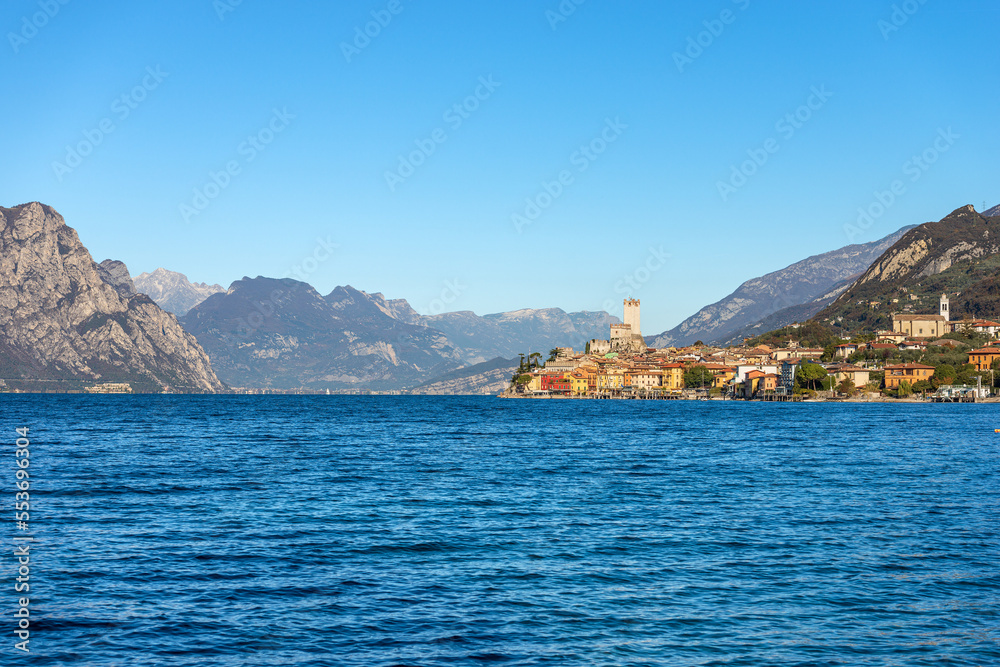 Malcesine village. Famous tourist resort on the coast of Lake Garda (Lago di Garda) with the castle. Verona province, Italy, Veneto, southern Europe. On background the mountain range of Italian Alps.