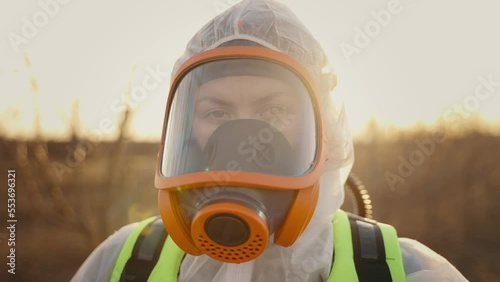 Portrait of virologist worker in protective suit, goggles and respirator