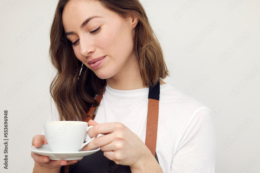 beautiful close-up portrait of happy woman and barista with cup of coffee
