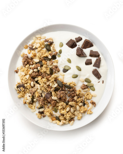 bowl of sweet cereal and seeds, with milk and chocolate, isolated on white background, top view