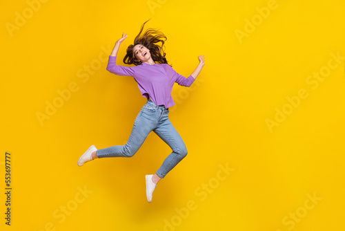 Full length photo of crazy satisfied person jumping empty space ad isolated on yellow color background