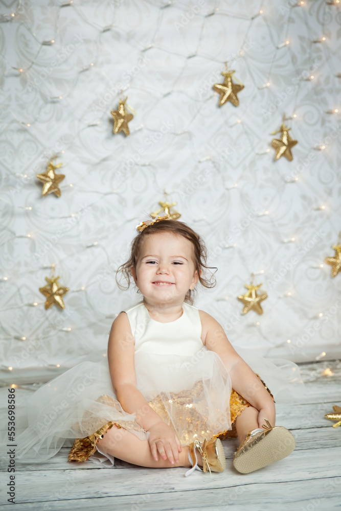 cute baby girl in a white and gold dress cute baby girl in a white and gold dress