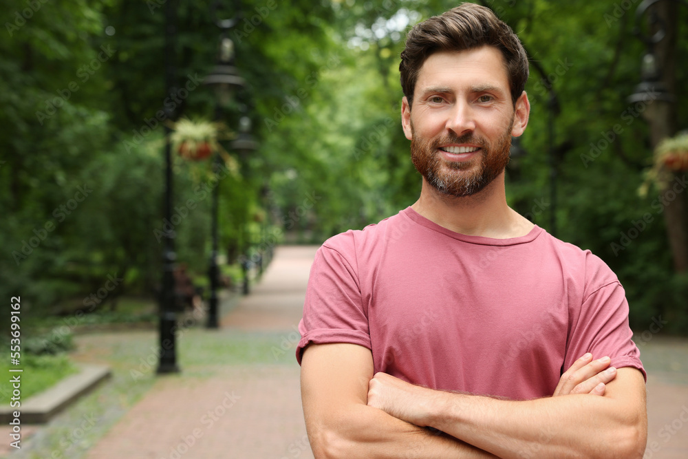 Portrait of handsome bearded man in park, space for text Portrait of handsome bearded man in park, space for text