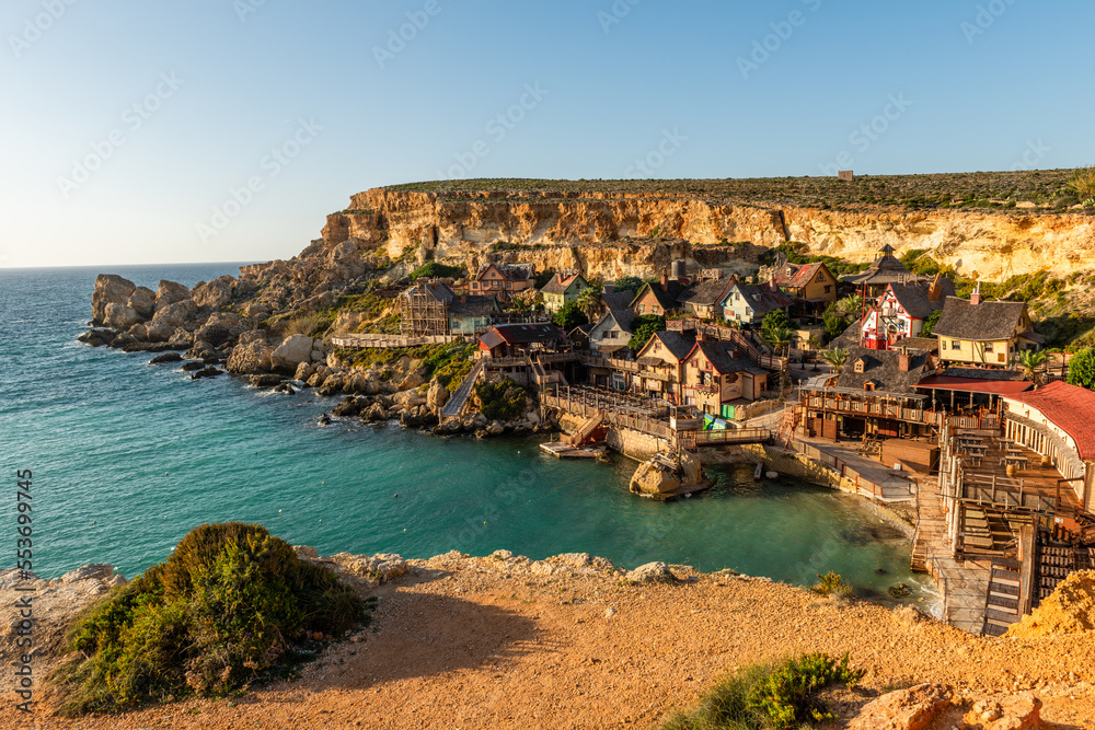 Il-Mellieha, Malta - Panoramic skyline view of the famous Popeye Village at Anchor Bay at sunset