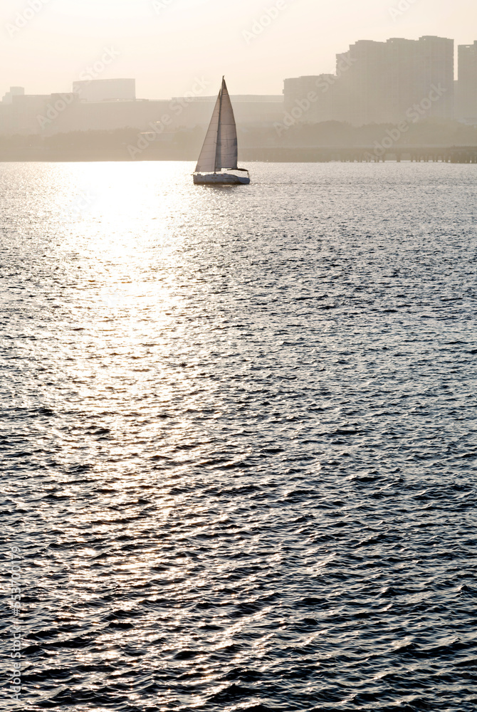 Sailboat in the sea at sunrise