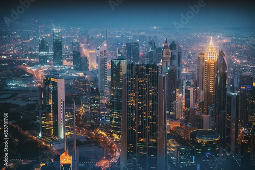 Aerial View Of Evening Night Traffic Of Residential District. Street Night Illumination Of Residential District In Dubai. Night Scenic View Of Skyscraper In Dubai. High quality photo.