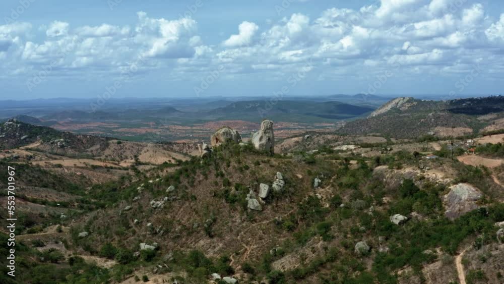 Dolly in aerial drone shot of unique rock formations surrounded by dry countryside valleys and hills near the small countryside mountain town of Monte das Gameleiras in Rio Grande do Norte, Brazil Dolly in aerial drone shot of unique rock formations surrounded by dry countryside valleys and hills near the small countryside mountain town of Monte das Gameleiras in Rio Grande do Norte, Brazil