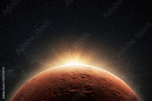 Fototapeta Naklejka Na Ścianę i Meble -  Amazing beautiful planet Mars with craters in stellar space with the sunrise light.