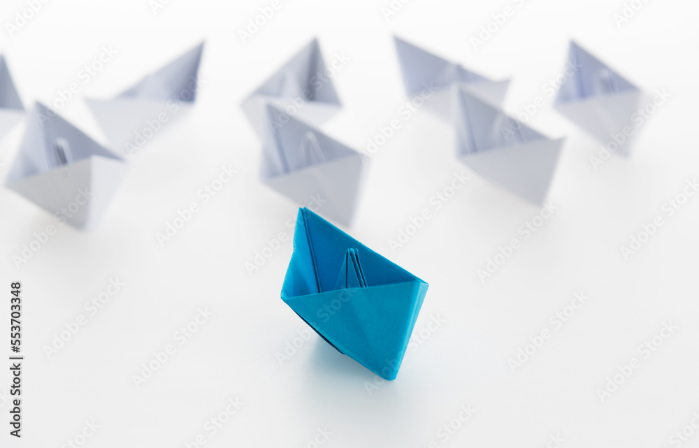 The blue origami boat is leader The blue origami boat is leader