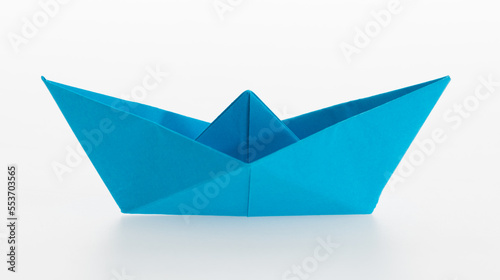 Blue origami boat on white background