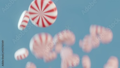 Peppermint candies falls in slow motion, light blue background