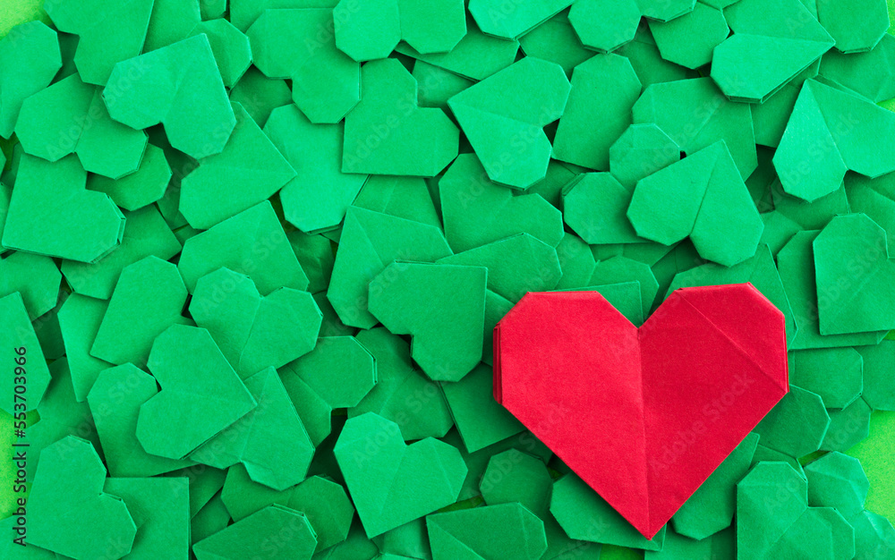Obraz premium Red origami heart on green origami hearts