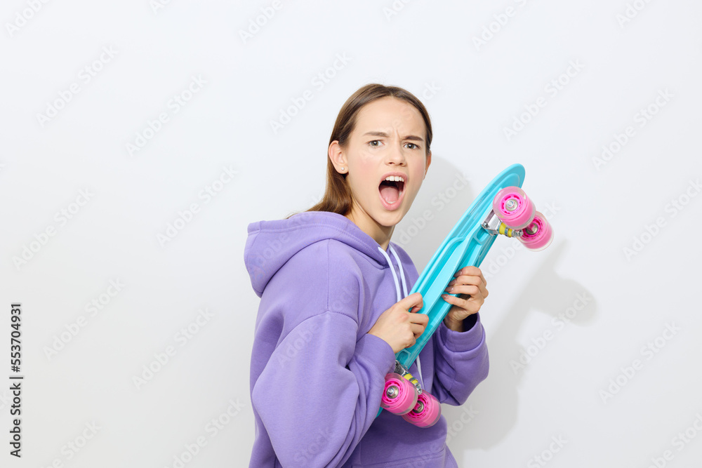 an emotional woman stands half sideways on a white background in a purple suit screams looking straight holding a skate in front of her
