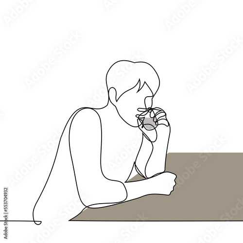 a man sits alone and drinks alcohol from a glass - one line drawing vector. concept alcoholic drinks vodka