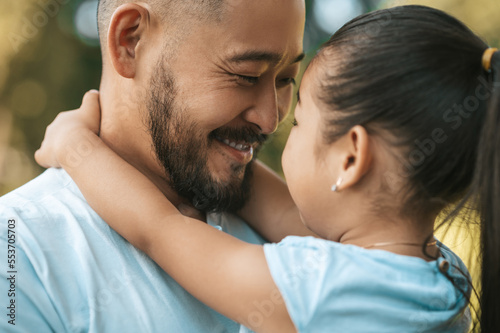 Cute little asian girl with father looking happy