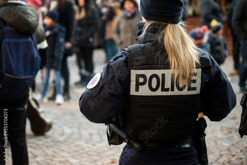 Portrait on back view of french policewoman standing in the street