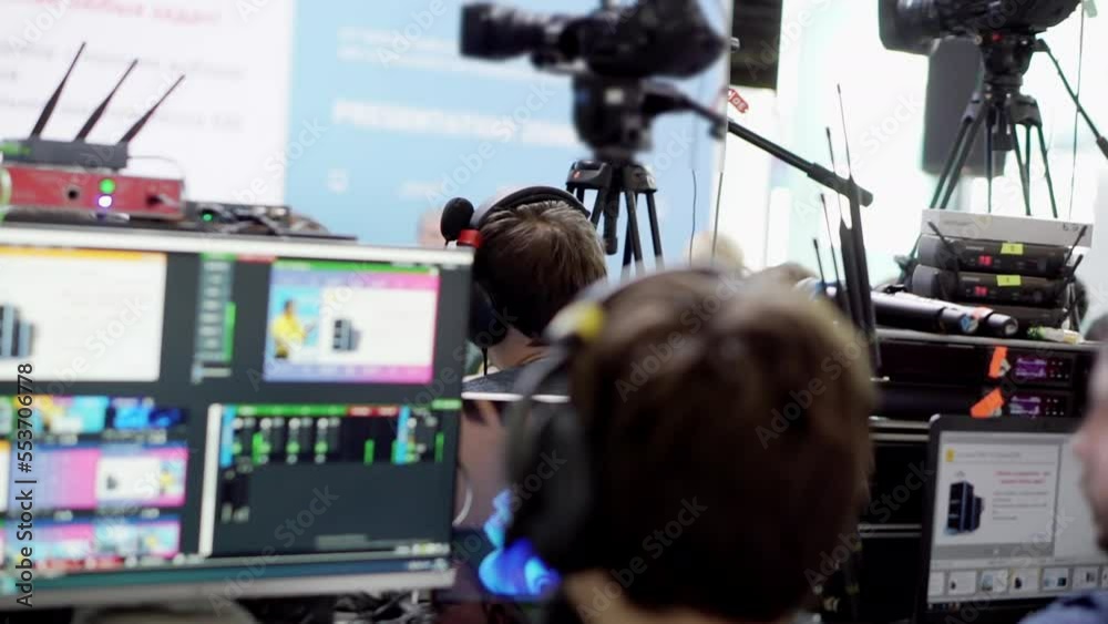 Videographer filming the speakers at a presentation. Videographer filming the speakers at a presentation.