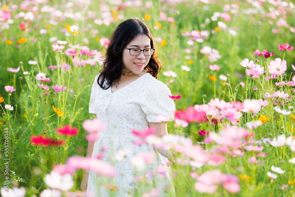 Portrait of asian Young woman happy traveler with white dress enjoying in Yellow and pink sulfur Cosmos flowers blooming field in the nature garden of in Chiang Mai,Thailand,travel relax vacation Portrait of asian Young woman happy traveler with white dress enjoying in Yellow and pink sulfur Cosmos flowers blooming field in the nature garden of in Chiang Mai,Thailand,travel relax vacation