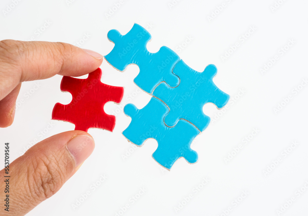 Hand put the red piece in blue puzzles Hand put the red piece in blue puzzles