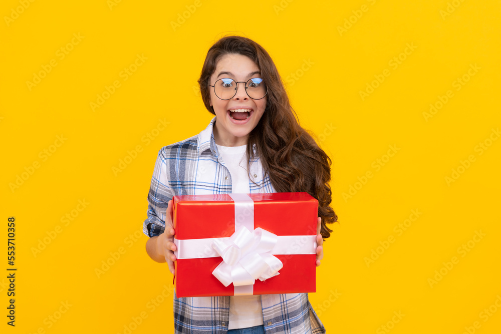 amazed teen girl in glasses with present. studio shot of teen girl hold present. teen girl amazed teen girl in glasses with present. studio shot of teen girl hold present. teen girl
