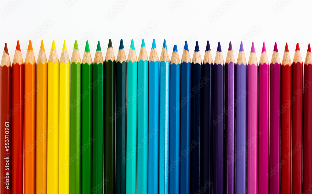 A row of colorful pencils on white background A row of colorful pencils on white background