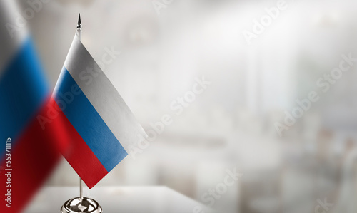 Foto Small flags of the Russia on an abstract blurry background