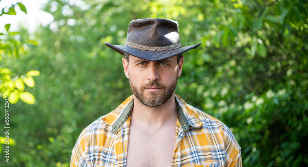 man face in cowboy hat. sexy man in checkered shirt. western man wearing hat