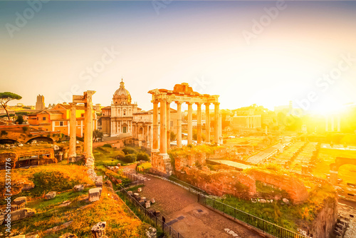 Forum - Roman ruins with cityscape of Rome with warm sunrire light, Italy
