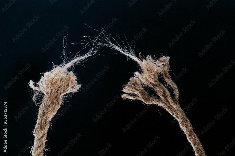 Foto Broken rope on black background