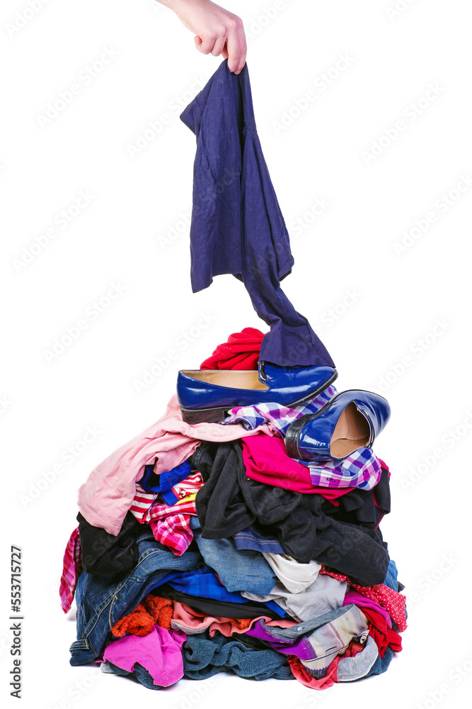 Hand put one item to pile of old used clothes isolated on white Hand put one item to pile of old used clothes isolated on white