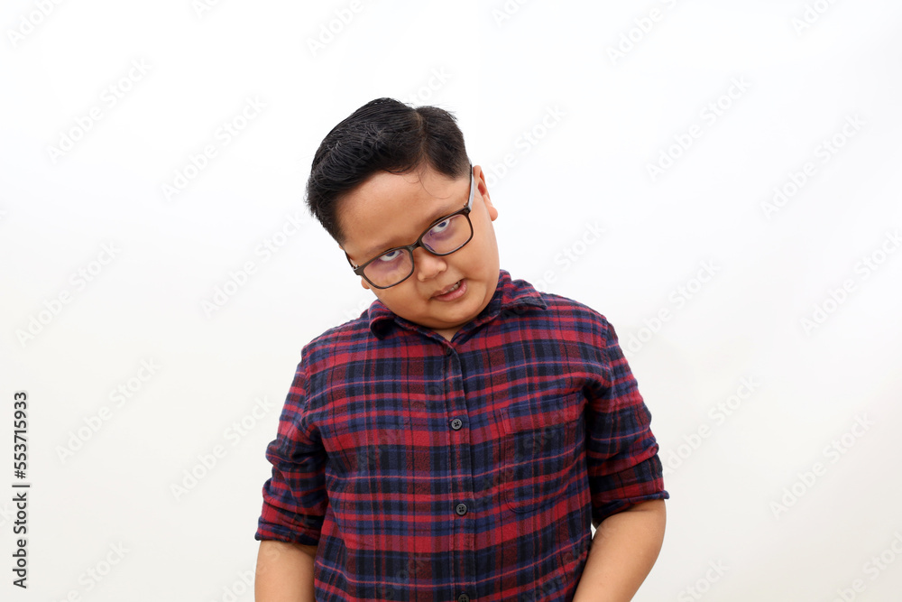 Adorable asian boy with eyeglasses standing while showing funny face. Isolated on white background Adorable asian boy with eyeglasses standing while showing funny face. Isolated on white background