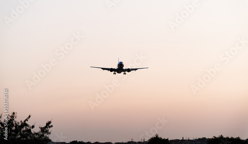 Background of airplane landing at sunset