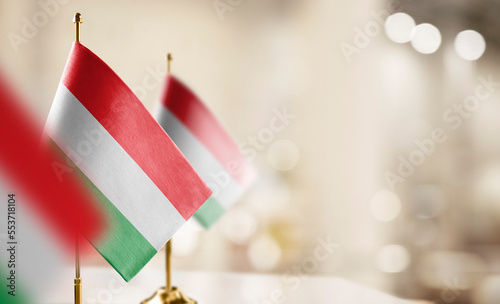 Obraz na plátně Small flags of the Hungary on an abstract blurry background