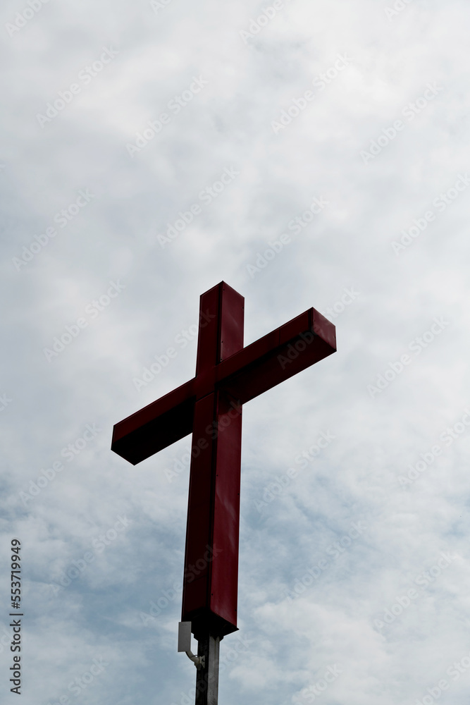 A cross under the cloudy sky
