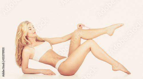 Shaving legs. Spa, depilation and bodycare concept. Legs of healthy girl shaving it carefully