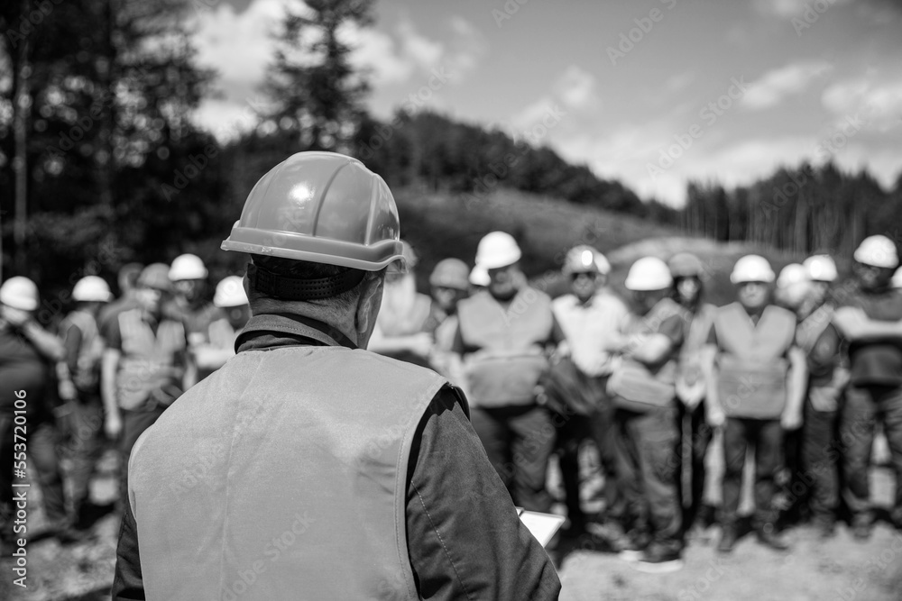 Building concept. Architector, engineers on constructing site. Builder man. Black and white Building concept. Architector, engineers on constructing site. Builder man. Black and white