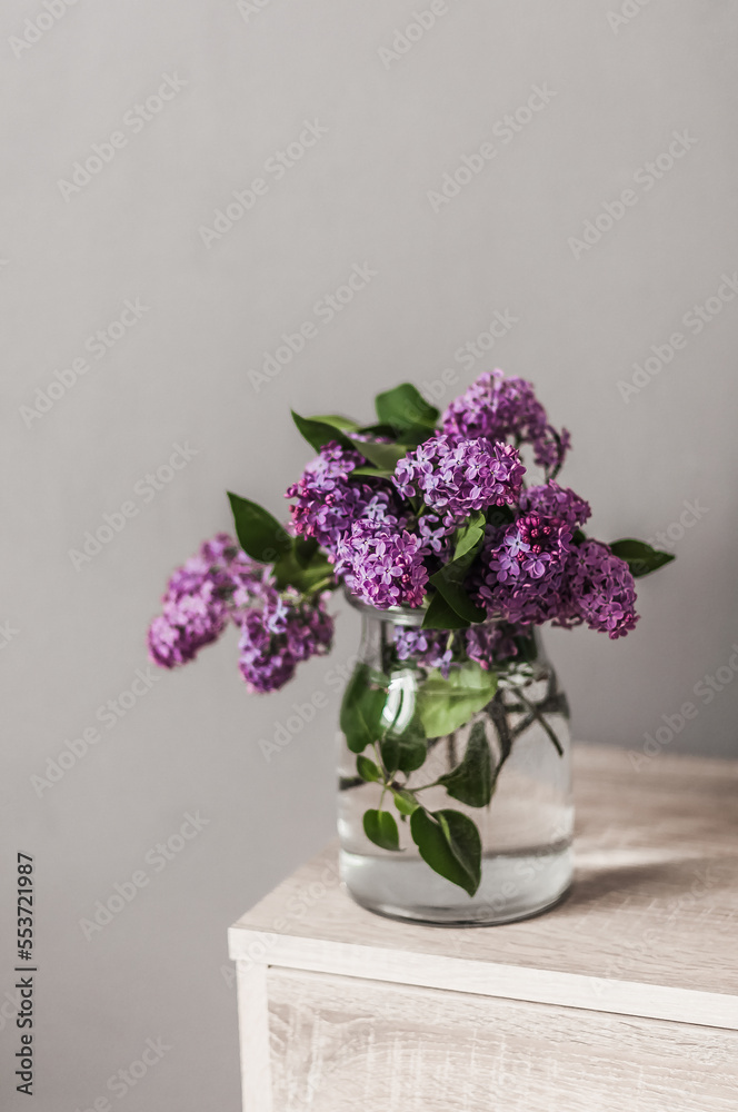 A bouquet of fresh lilacs in a glass vase.