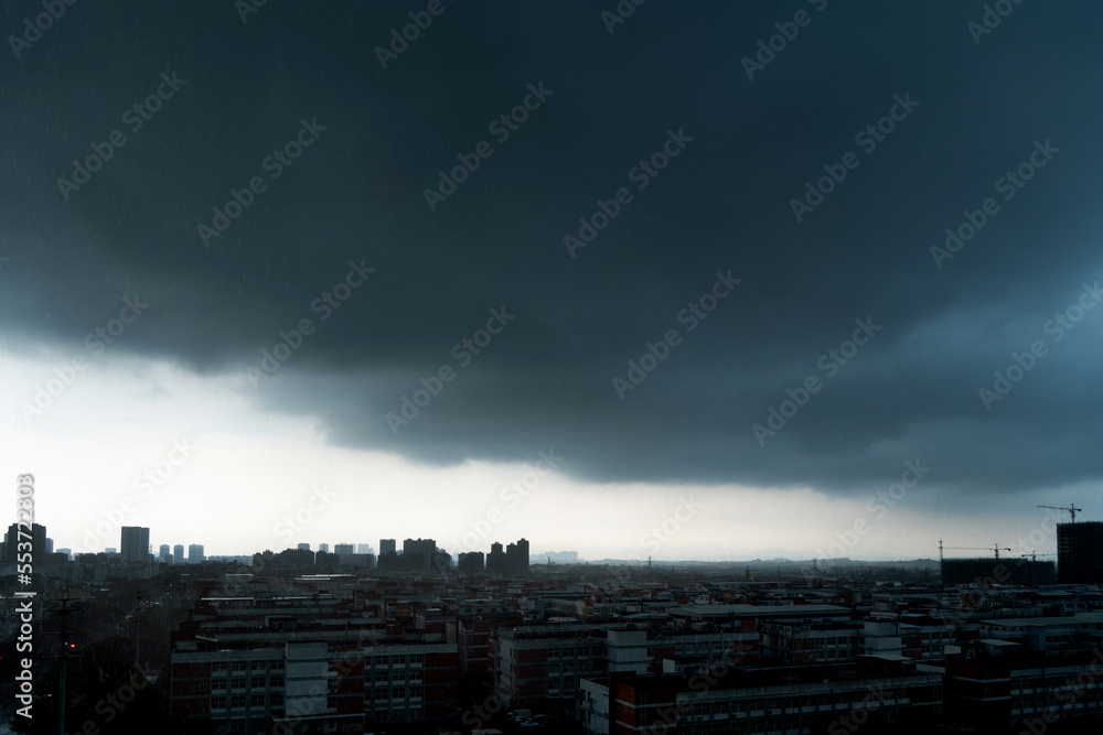 Dark clouds over the city buildings