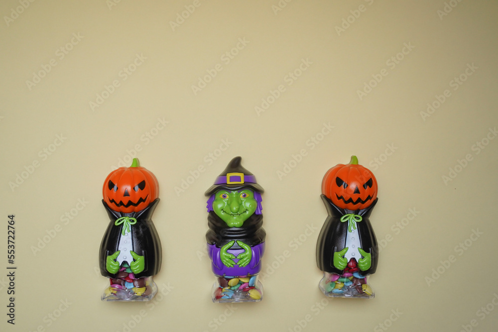 Cute character in monster costume. Scary Halloween figurines stand on a light background in close-up