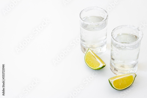 Tequila with lime and salt in glasses, top view