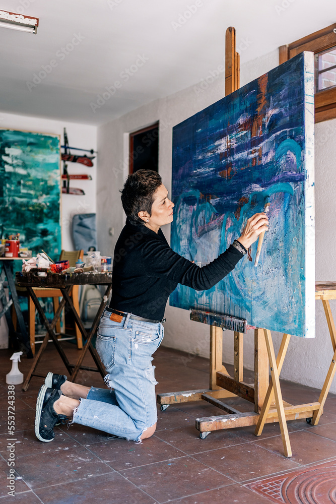 Female Artist Painting in Big Canvas Female Artist Painting in Big Canvas