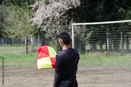 soccer referee, standing with a pennant in his hand. football referee on the field photo