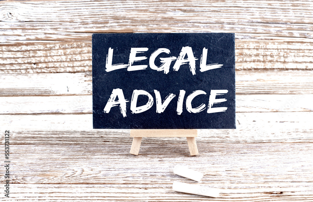 Fototapeta premium LEGAL ADVICE text on the Miniature chalkboard on wooden background