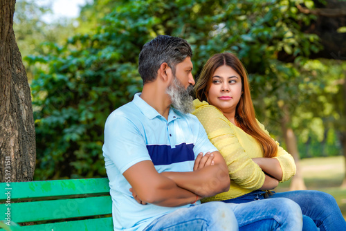 Indian couple giving angry expression at park. © Niks Ads