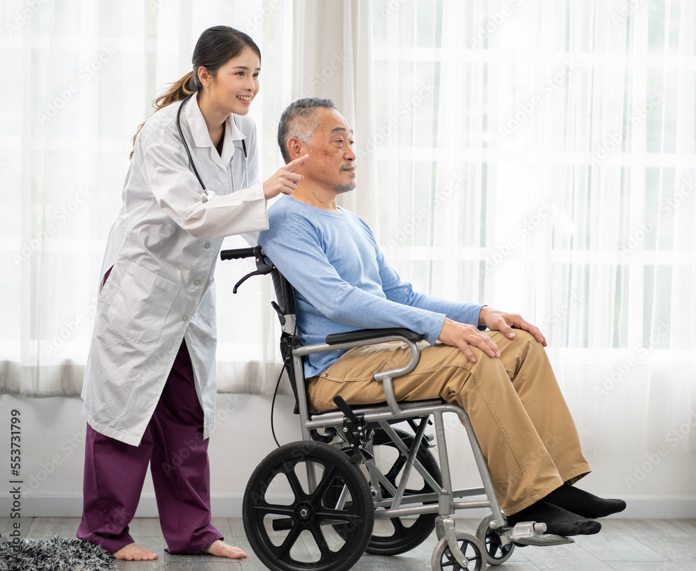 Senior man patient is in wheelchair and young female nurse taking care of him in nursing home. Asian doctor woman supports old man patient to recovery at hospital. Aged people at rehabilitation. Senior man patient is in wheelchair and young female nurse taking care of him in nursing home. Asian doctor woman supports old man patient to recovery at hospital. Aged people at rehabilitation.