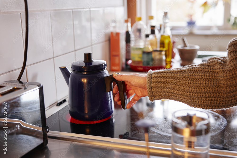Woman preparing coffee in kitchen Woman preparing coffee in kitchen