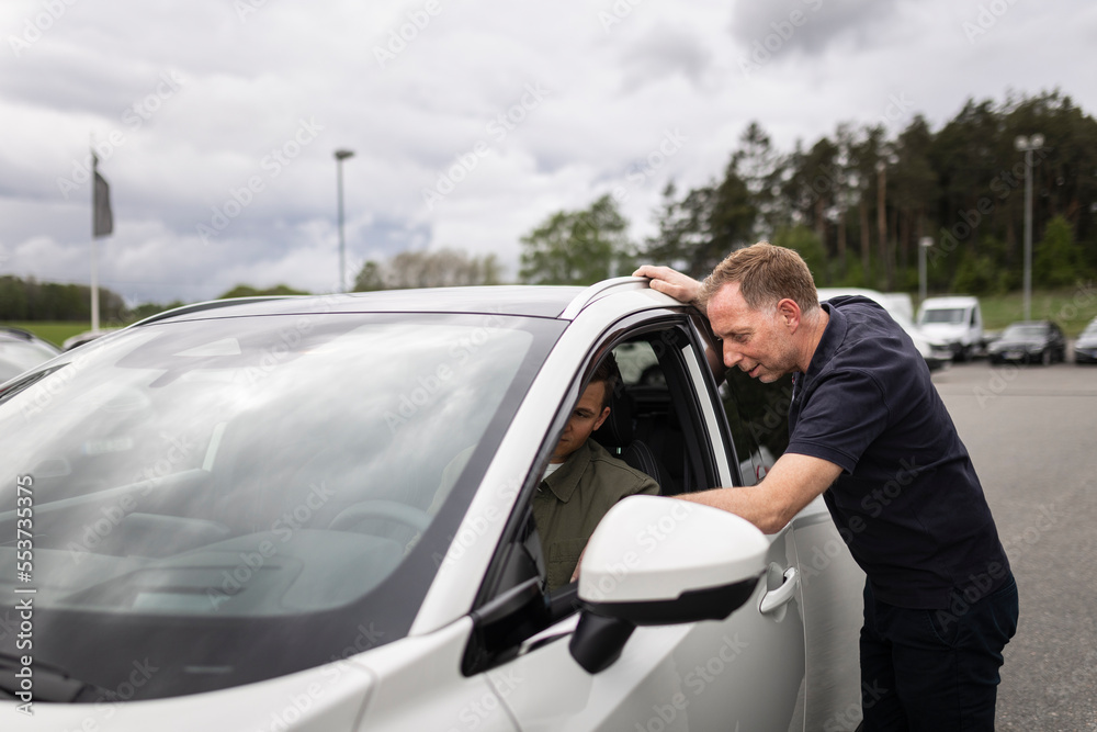 Man trying car in car dealership Man trying car in car dealership