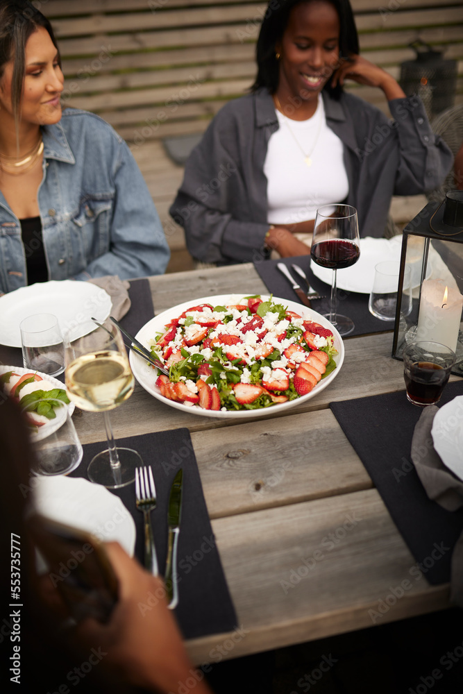 Friends having meal in garden