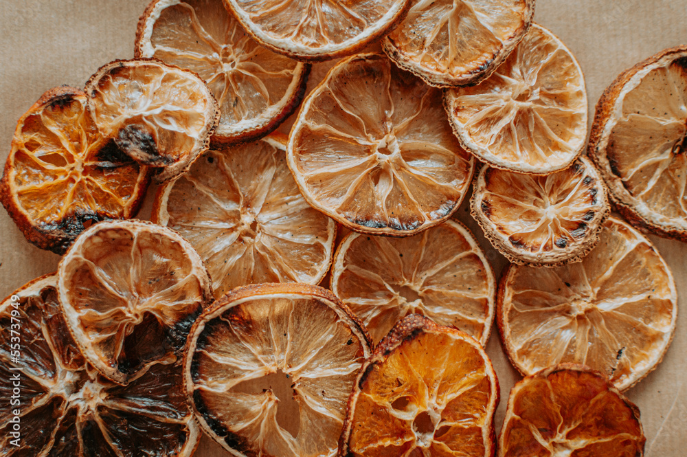 Dried orange, lemon, and tangerine slices. Candied citrus fruit food background. Top view with copy space for text. Flat lay. Concept of holiday homemade craft and presents, zero waste, natural decor. Dried orange, lemon, and tangerine slices. Candied citrus fruit food background. Top view with copy space for text. Flat lay. Concept of holiday homemade craft and presents, zero waste, natural decor.